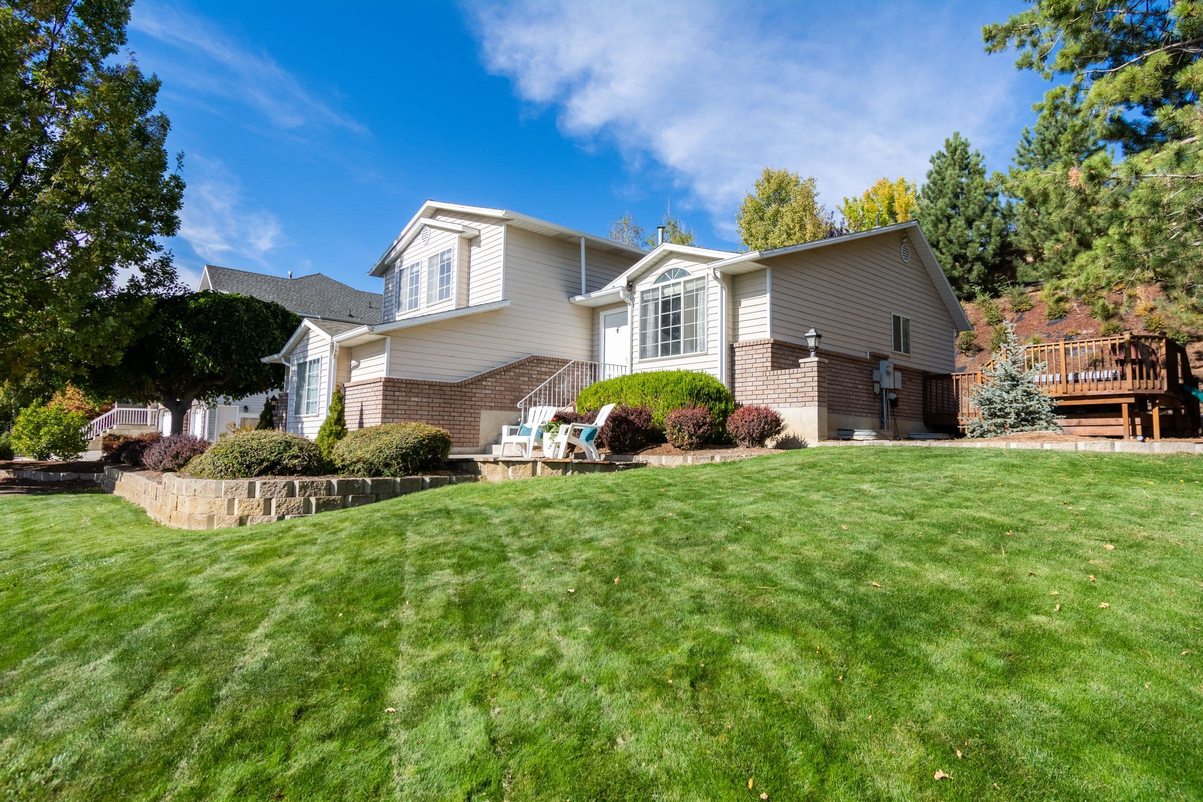 A green, well-maintained lawn in front of a home